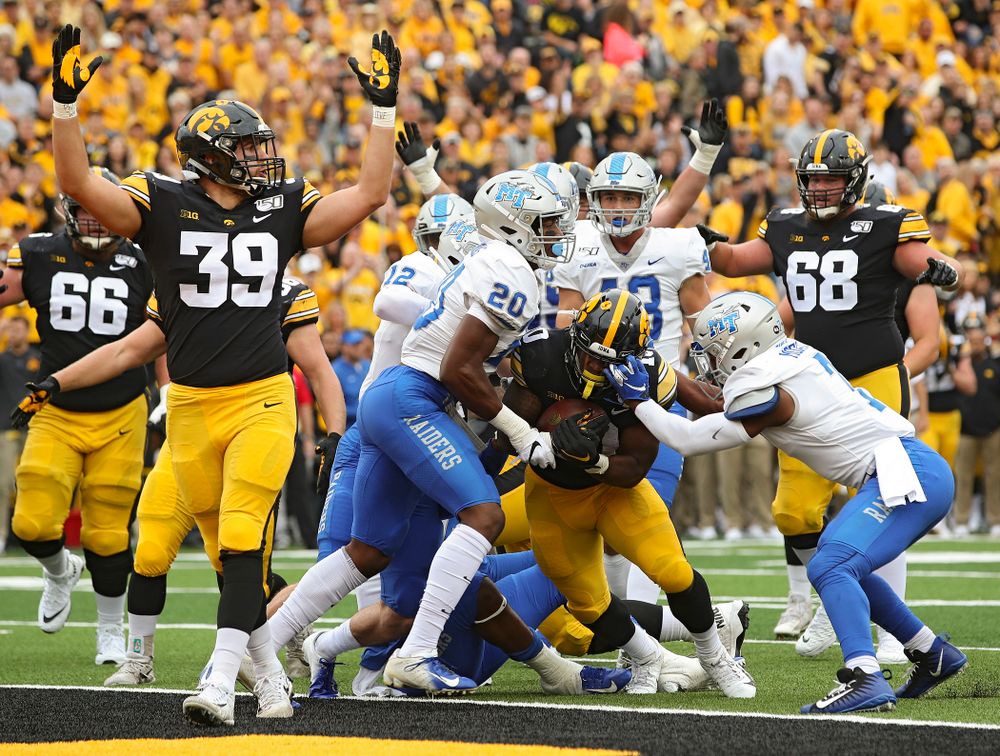 Iowa Hawkeyes running back Mekhi Sargent (10) scores a touchdown on a 4-yard run as tight end Nate Wieting (39) raises his arms during the first quarter of their game at Kinnick Stadium in Iowa City on Saturday, Sep 28, 2019. (Stephen Mally/hawkeyesports.com)