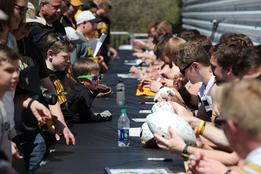 Members of the Iowa Football team sign autographs before the Iowa Hawkeyes game against the Nebraska Cornhuskers Saturday, April 20, 2019 at Duane Banks Field. (Brian Ray/hawkeyesports.com)