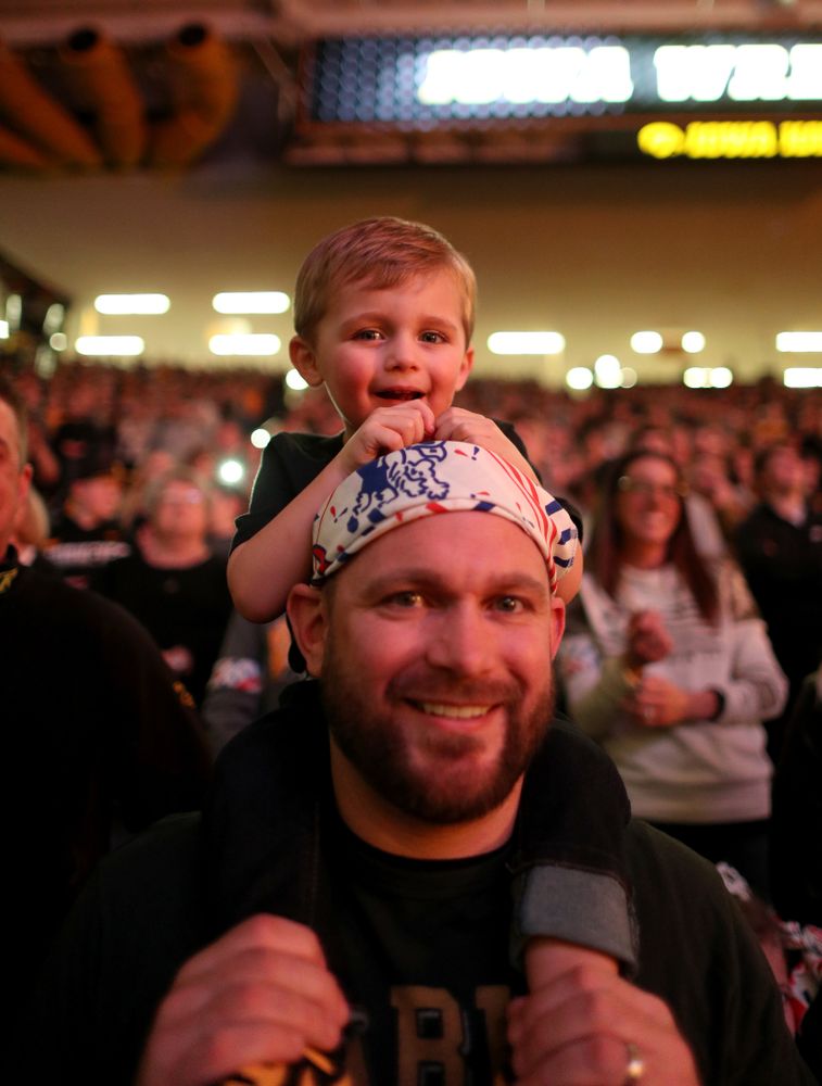 A young fan cheers on the Iowa Hawkeyes before their meet against Nebraska Saturday, January 18, 2020 at Carver-Hawkeye Arena. Assad won the match 6-4. (Brian Ray/hawkeyesports.com)