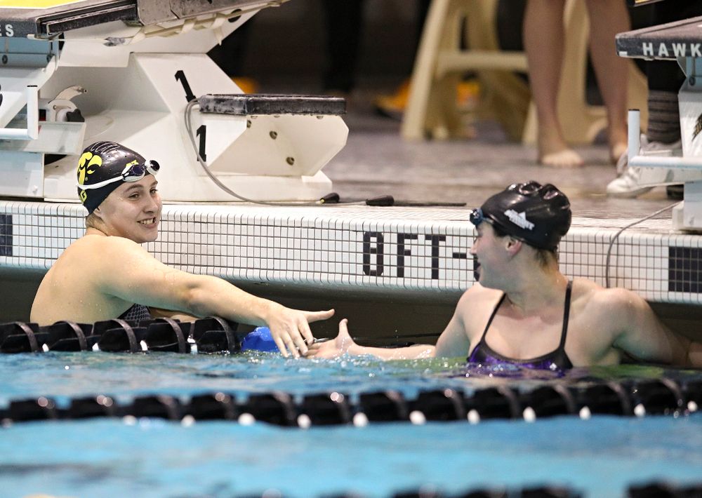Iowa’s Maddie Ziegert (from left) is congratulated by Western Illinois’ Miranda Mathus after Ziegert won the women’s 50 yard butterfly event during their meet at the Campus Recreation and Wellness Center in Iowa City on Friday, February 7, 2020. (Stephen Mally/hawkeyesports.com)