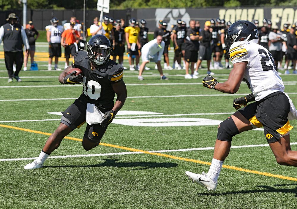 Iowa Hawkeyes running back Mekhi Sargent (10) eyes defensive back Kaevon Merriweather (26) after pulling in a pass during Fall Camp Practice No. 7 at the Hansen Football Performance Center in Iowa City on Friday, Aug 9, 2019. (Stephen Mally/hawkeyesports.com)