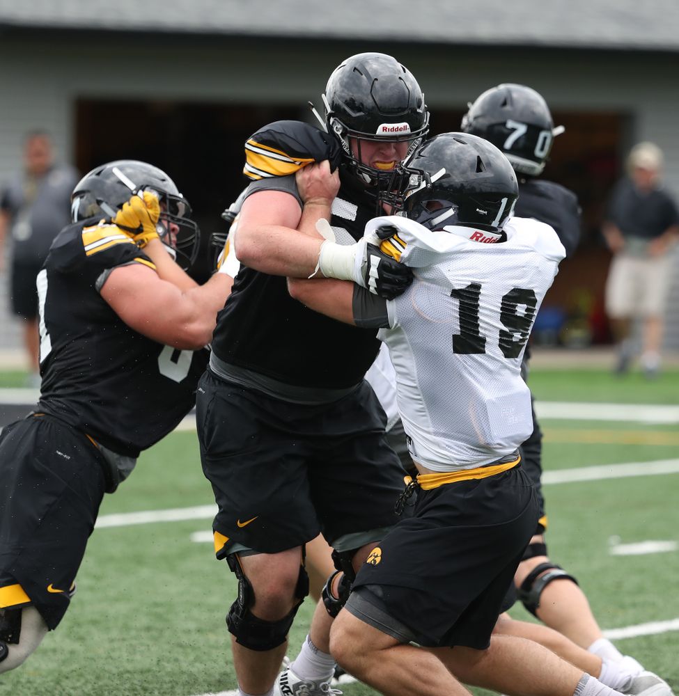 Iowa Hawkeyes offensive lineman Matt Fagan (54) and  linebacker Mike Timm (19) and during practice No. 4 of Fall Camp Monday, August 6, 2018 at the Hansen Football Performance Center. (Brian Ray/hawkeyesports.com)