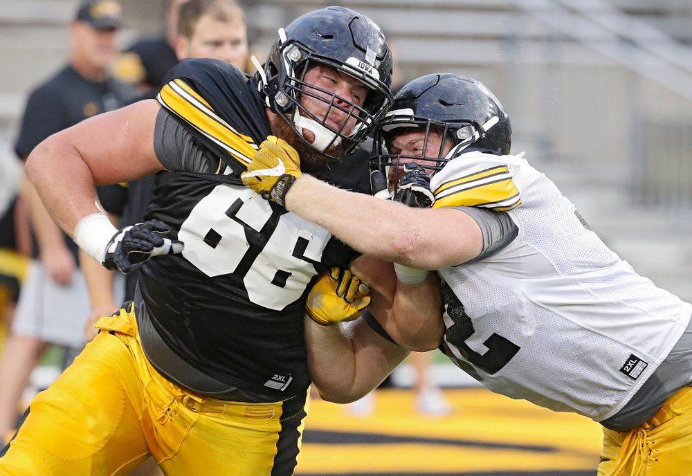 Iowa Hawkeyes offensive lineman Levi Paulsen (66) and defensive lineman John Waggoner (92) run a drill during Fall Camp Practice No. 12 at Kinnick Stadium in Iowa City on Thursday, Aug 15, 2019. (Stephen Mally/hawkeyesports.com)
