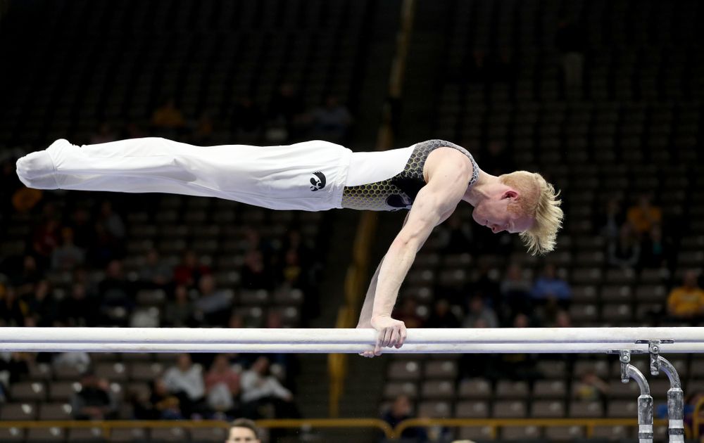 Iowa’s Nick Merryman competes on the parallel bars against UIC and Minnesota Saturday, February 1, 2020 at Carver-Hawkeye Arena. (Brian Ray/hawkeyesports.com)