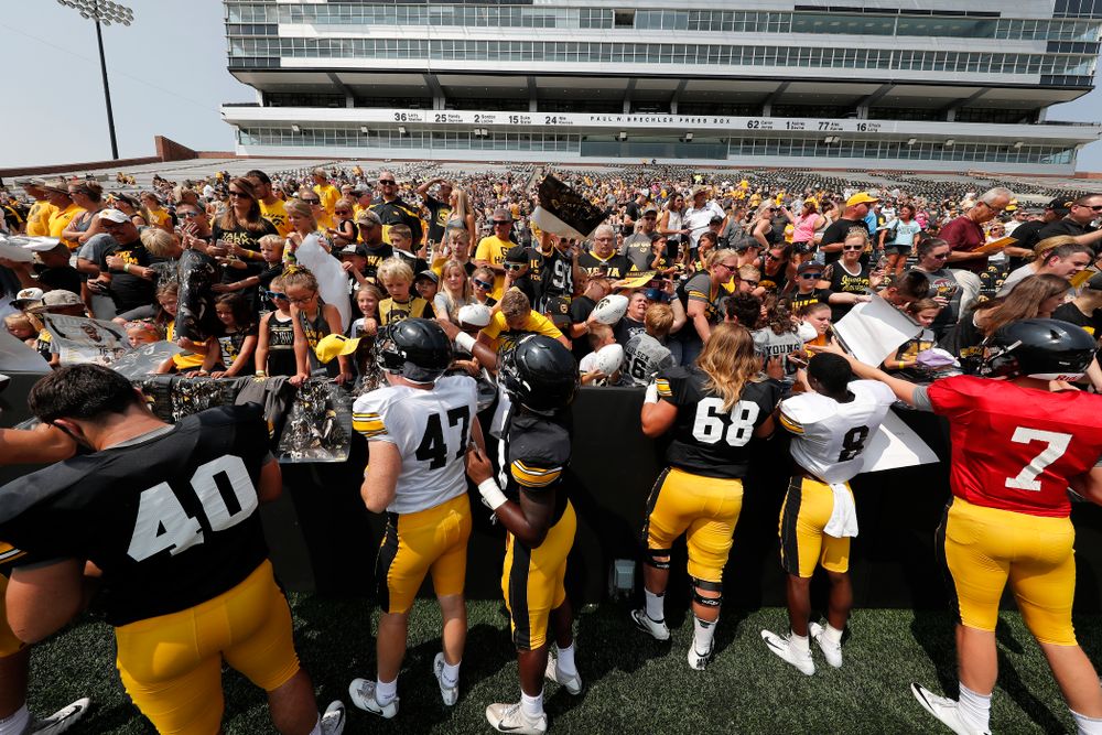 Members of the Hawkeye Football team sign autographs during Kids Day Saturday, August 11, 2018 at Kinnick Stadium. (Brian Ray/hawkeyesports.com)