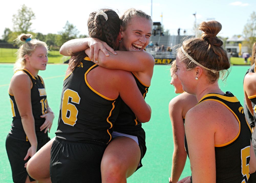 Iowa’s Katie Birch (11) jumps into the arms of Anthe Nijziel (6) after defeating Rutgers in their match at Grant Field in Iowa City on Friday, Oct 4, 2019. (Stephen Mally/hawkeyesports.com)