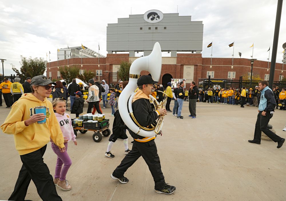 A man plays a sousaphone as he walks along Melrose Avenue before the game at Kinnick Stadium in Iowa City on Saturday, Oct 19, 2019. (Stephen Mally/hawkeyesports.com)