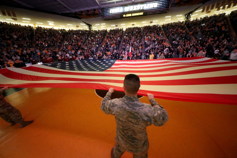 Members of the military spread out a large flag during the National Anthem before the Iowa Hawkeyes meet against Minnesota Saturday, February 15, 2020 at Carver-Hawkeye Arena. (Brian Ray/hawkeyesports.com)
