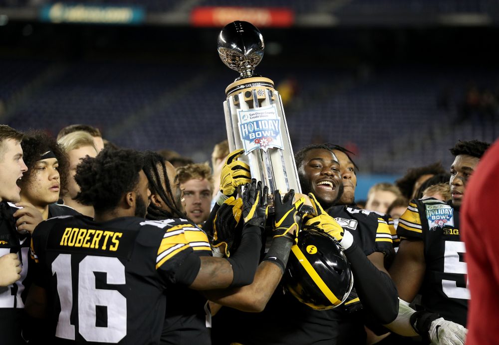 Iowa Hawkeyes defensive tackle Daviyon Nixon (54) holds the Holiday Bowl trophy following their win against USC in the Holiday Bowl Friday, December 27, 2019 at San Diego Community Credit Union Stadium.  (Brian Ray/hawkeyesports.com)