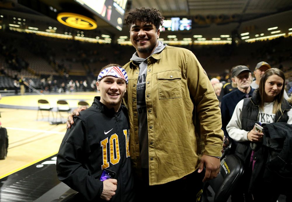 Iowa’s Spencer Lee takes a photo with Hawkeye Football’s Tristan Wirfs following their win over the Nebraska’s Cornhuskers Saturday, January 18, 2020 at Carver-Hawkeye Arena. (Brian Ray/hawkeyesports.com)