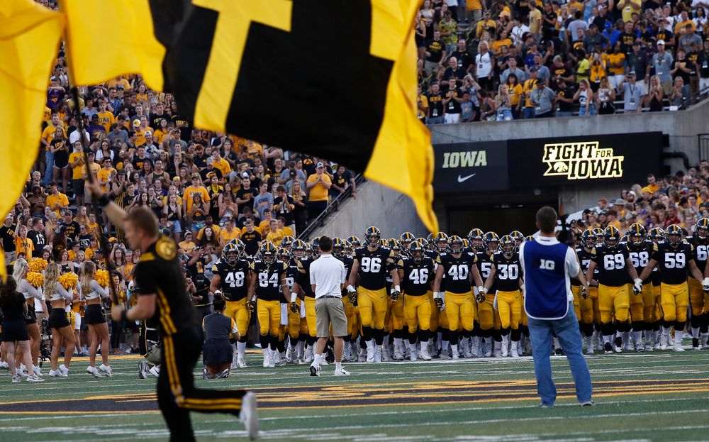 The Iowa Hawkeyes football team swarms the field before a game against Northern Iowa at Kinnick Stadium on September 15, 2018. (Tork Mason/hawkeyesports.com)