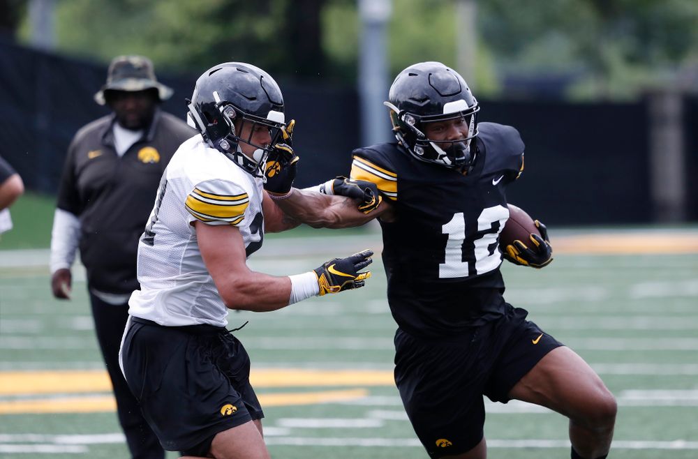 Iowa Hawkeyes wide receiver Brandon Smith (12)  and defensive back Amani Hooker (27) during practice No. 4 of Fall Camp Monday, August 6, 2018 at the Hansen Football Performance Center. (Brian Ray/hawkeyesports.com)