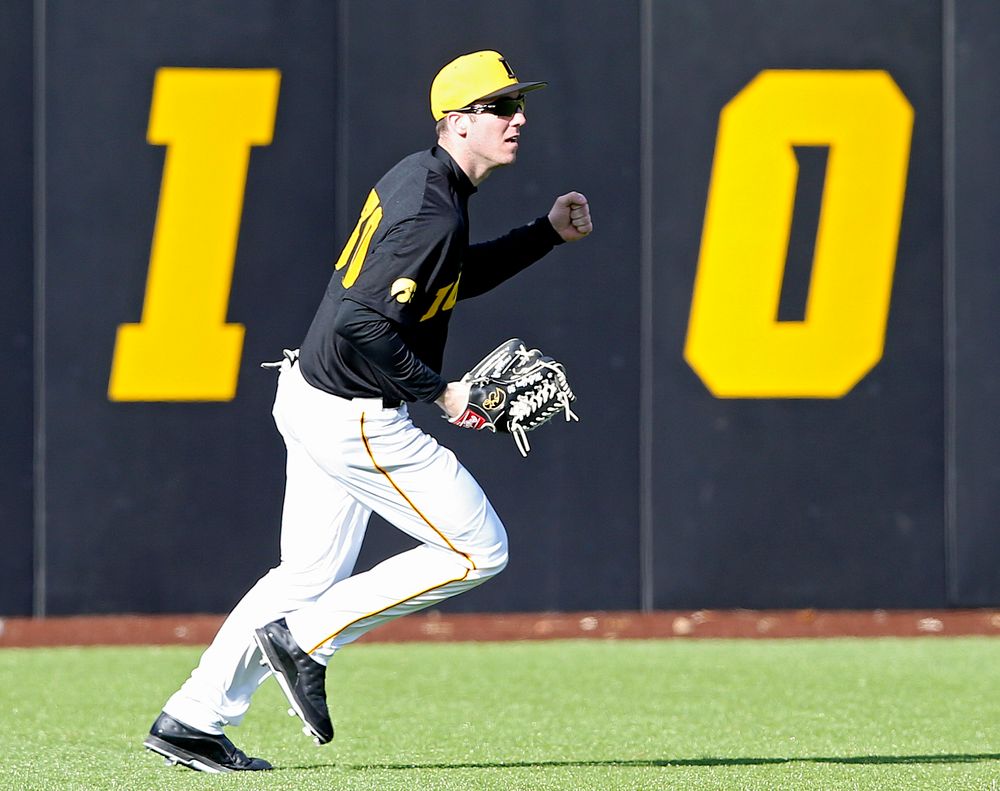 Iowa Hawkeyes left fielder Connor McCaffery (30) pumps his fist after catching a fly ball for the final out of the ninth inning of their game against Illinois at Duane Banks Field in Iowa City on Saturday, Mar. 30, 2019. (Stephen Mally/hawkeyesports.com)