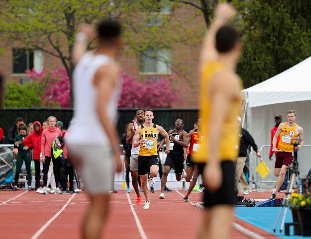 Iowa's Carter Lilly (right) waves at Chris Thompson as he approaches during the 1600 meter relay event on the third day of the Big Ten Outdoor Track and Field Championships at Francis X. Cretzmeyer Track in Iowa City on Sunday, May. 12, 2019. (Stephen Mally/hawkeyesports.com)