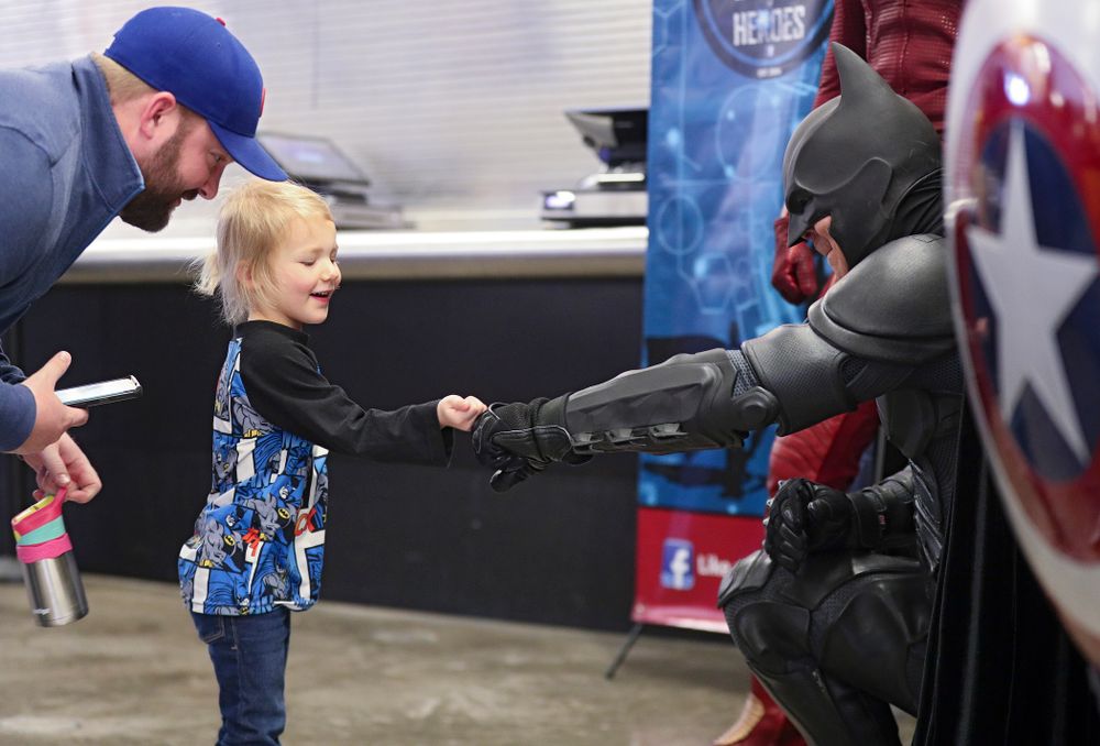 A young fan gets a fist bump from Batman on Superhero and Princess Day before the meet at Carver-Hawkeye Arena in Iowa City on Sunday, March 8, 2020. (Stephen Mally/hawkeyesports.com)