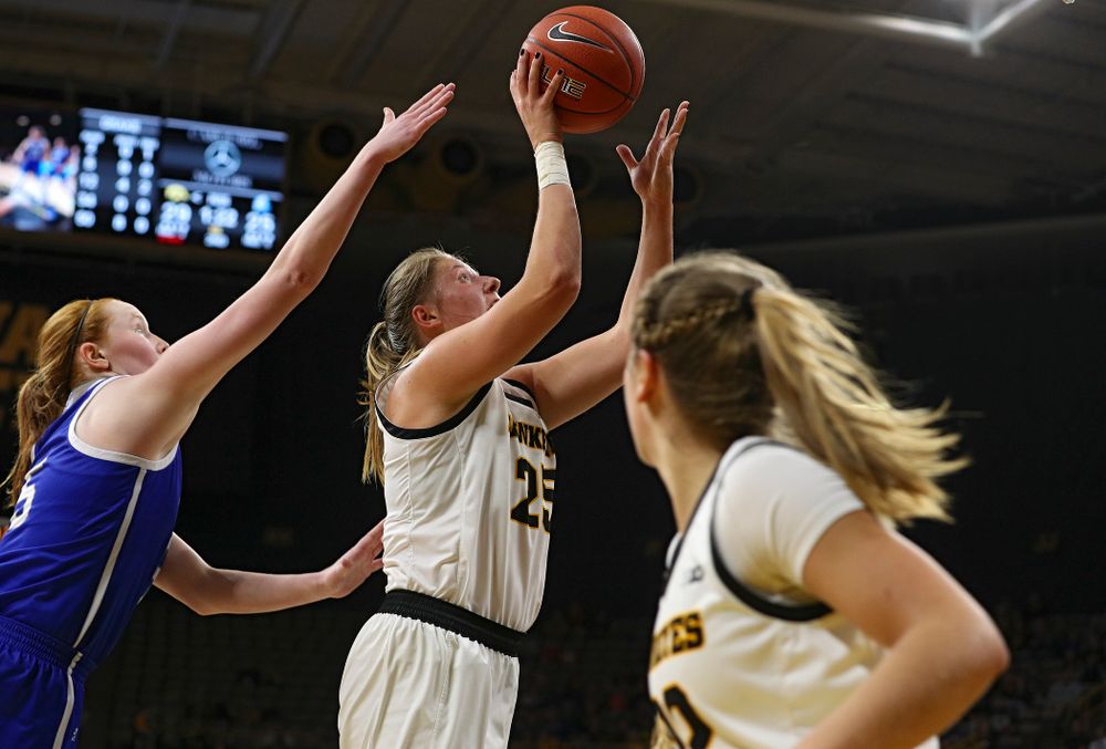 Iowa Hawkeyes forward Monika Czinano (25) scores a basket after taking a pass from guard Kathleen Doyle (22) during the second quarter of their game at Carver-Hawkeye Arena in Iowa City on Saturday, December 21, 2019. (Stephen Mally/hawkeyesports.com)