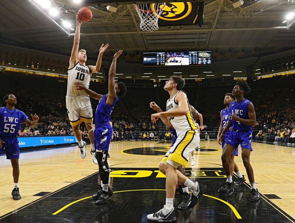 Iowa Hawkeyes guard Joe Wieskamp (10) makes a basket as center Luka Garza (55) looks on during the first half of their exhibition game against Lindsey Wilson College at Carver-Hawkeye Arena in Iowa City on Monday, Nov 4, 2019. (Stephen Mally/hawkeyesports.com)
