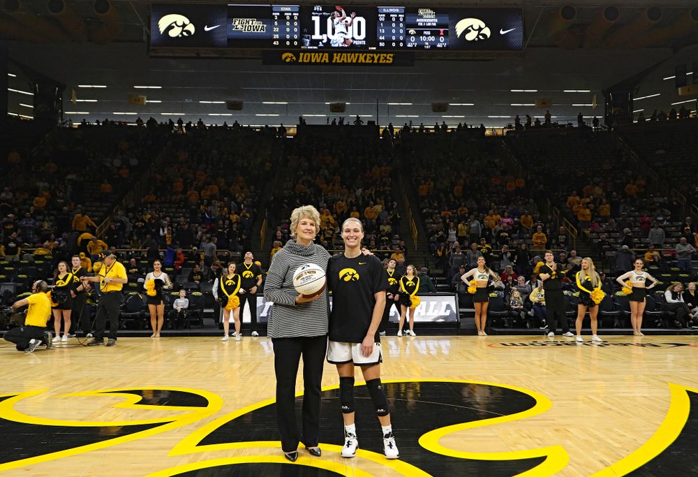 Iowa Hawkeyes head coach Lisa Bluder presents guard Makenzie Meyer (3) with a ball to honor her for scoring 1,000 career points before their game at Carver-Hawkeye Arena in Iowa City on Tuesday, December 31, 2019. (Stephen Mally/hawkeyesports.com)
