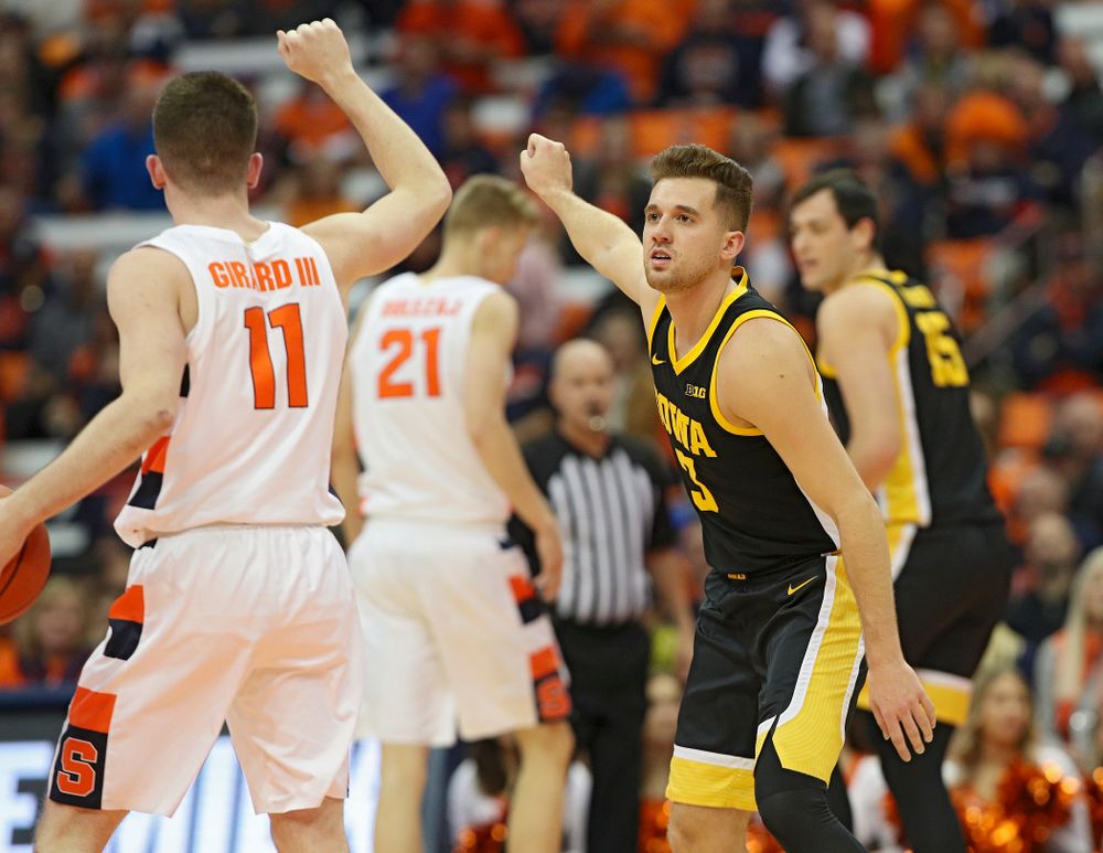 Iowa Hawkeyes guard Jordan Bohannon (3) copies the hand signal of Syracuse Orange guard Joseph Girard III (11) during the first half of their ACC/Big Ten Challenge game at the Carrier Dome in Syracuse, N.Y. on Tuesday, Dec 3, 2019. (Stephen Mally/hawkeyesports.com)
