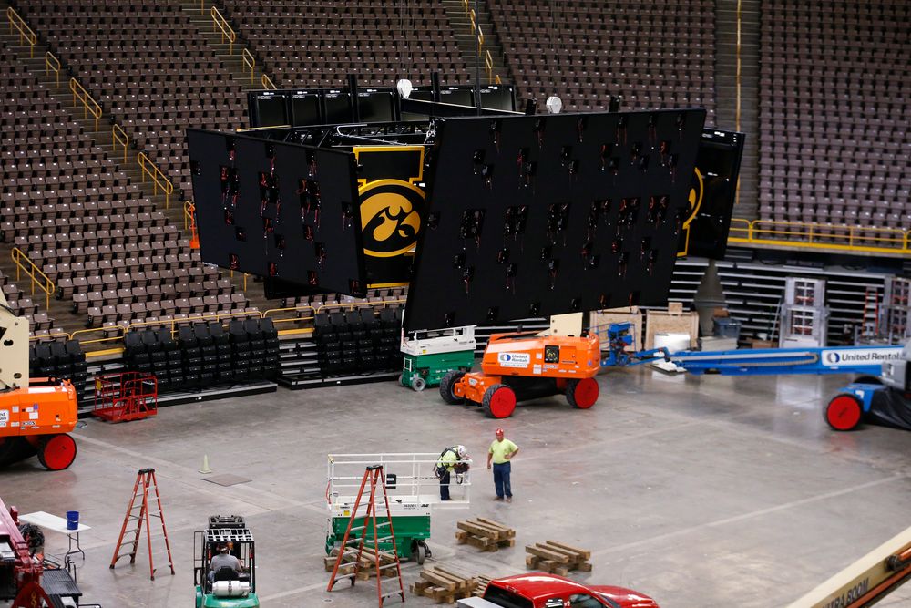 Workers raise the new centerhung video board