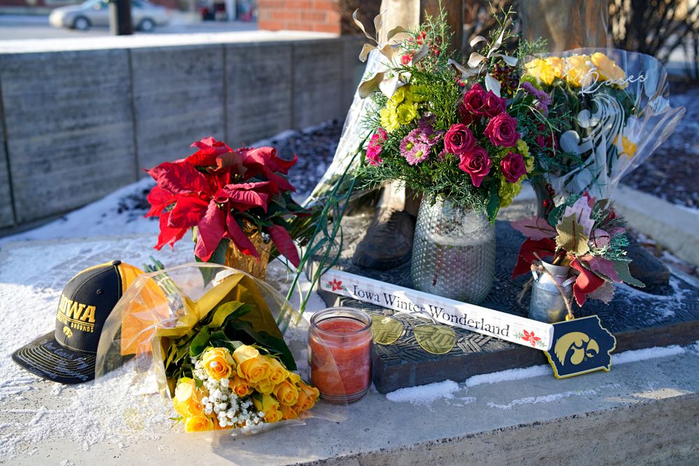A memorial at the base of the Hayden Fry statue in Coralville on Wednesday, December 18, 2019. Hayden Fry passed away on Dec. 17, at the age of 90. (Stephen Mally/hawkeyesports.com)