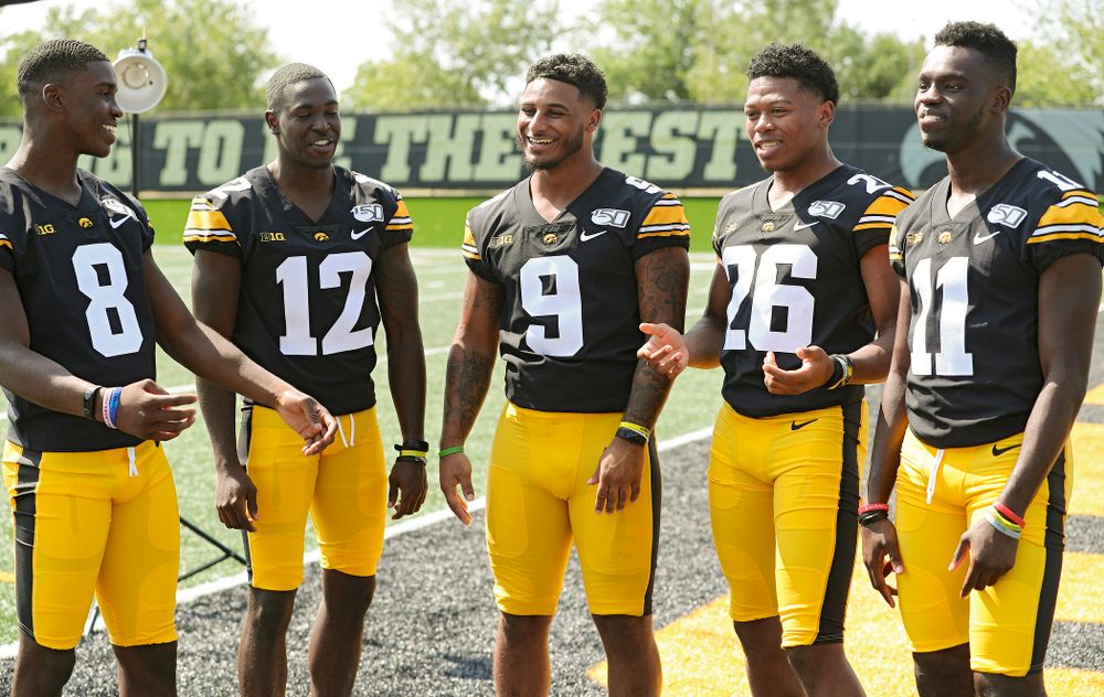 Iowa Hawkeyes defensive back Matt Hankins (8), defensive back D.J. Johnson (12), defensive back Geno Stone (9), defensive back Kaevon Merriweather (26), and defensive back Michael Ojemudia (11) pose for a picture during Iowa Football Media Day at the Hansen Football Performance Center in Iowa City on Friday, Aug 9, 2019. (Stephen Mally/hawkeyesports.com)