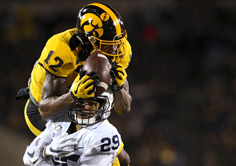 Iowa Hawkeyes wide receiver Brandon Smith (12) pulls in a touchdown pass over Penn State Nittany Lions cornerback John Reid (29) during the fourth quarter of their game at Kinnick Stadium in Iowa City on Saturday, Oct 12, 2019. (Stephen Mally/hawkeyesports.com)