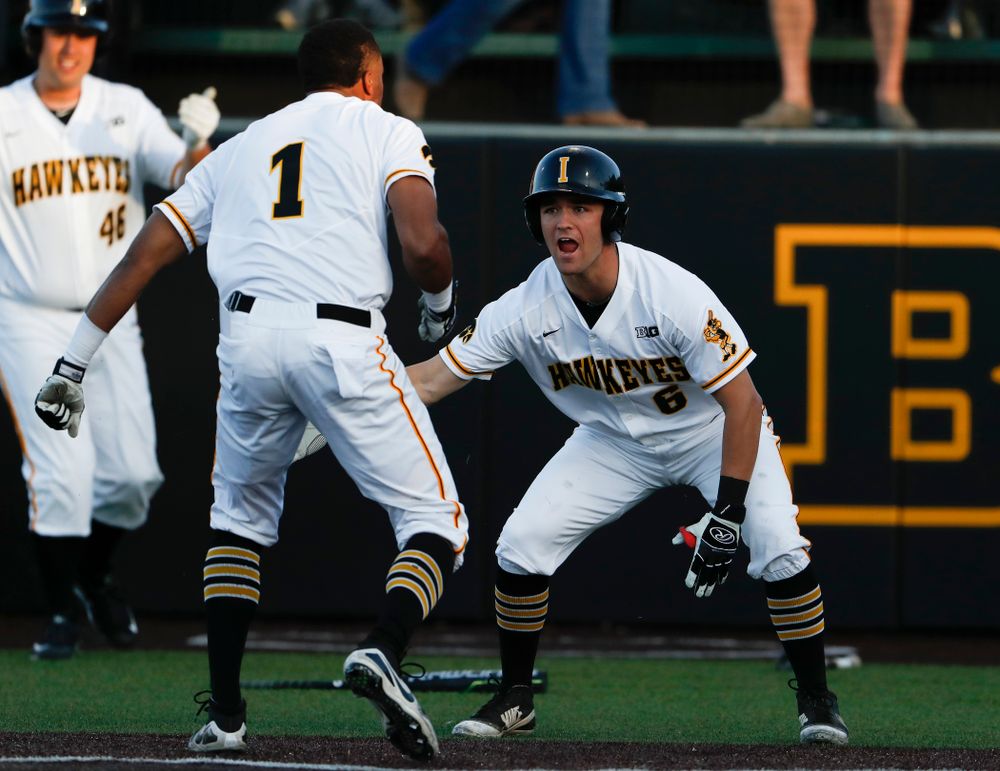 Iowa Hawkeyes third baseman Lorenzo Elion (1) celebrates with outfielder Justin Jenkins (6) against the Michigan Wolverines Friday, April 27, 2018 at Duane Banks Field in Iowa City. (Brian Ray/hawkeyesports.com)
