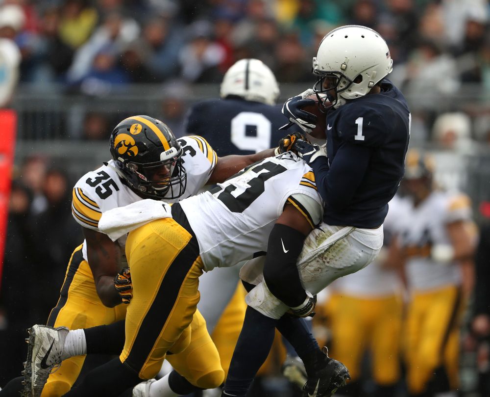 Iowa Hawkeyes wide receiver Dominique Dafney (23) hits Penn State Nittany Lions wide receiver KJ Hamler (1) on a kick off Saturday, October 27, 2018 at Beaver Stadium in University Park, Pa. (Brian Ray/hawkeyesports.com)