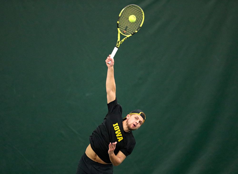 Iowa’s Will Davies serves during their doubles match against Marquette at the Hawkeye Tennis and Recreation Complex in Iowa City on Saturday, January 25, 2020. (Stephen Mally/hawkeyesports.com)