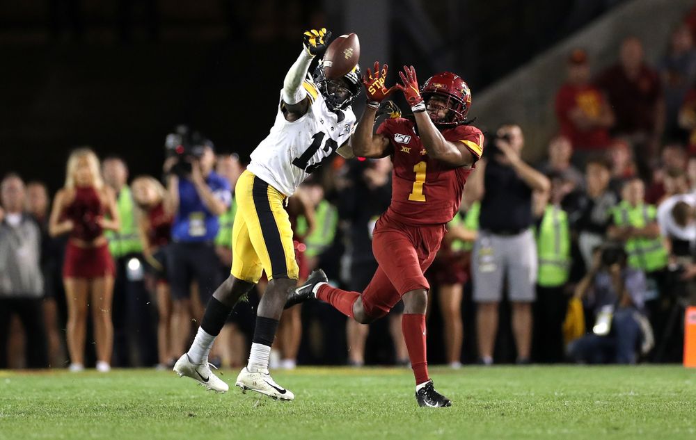 Iowa Hawkeyes defensive back D.J. Johnson (12) breaks up a pass  against the Iowa State Cyclones Saturday, September 14, 2019 in Ames, Iowa. (Brian Ray/hawkeyesports.com)