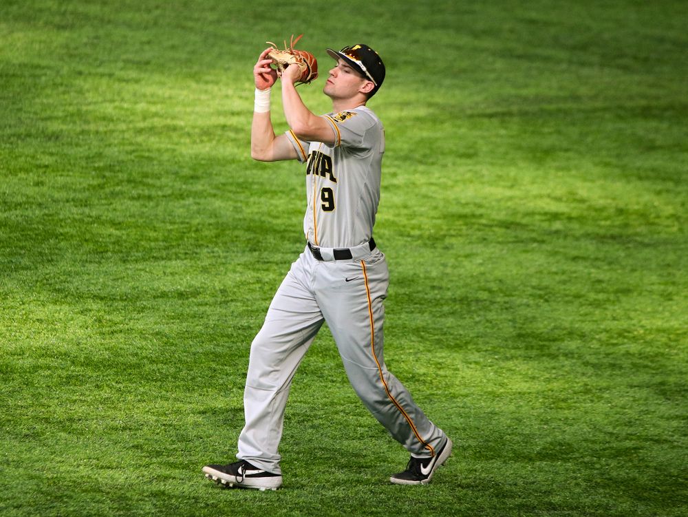 Iowa Hawkeyes outfielder Ben Norman (9) pulls in a fly ball for an out during the second inning of their CambriaCollegeClassic game at U.S. Bank Stadium in Minneapolis, Minn. on Friday, February 28, 2020. (Stephen Mally/hawkeyesports.com)