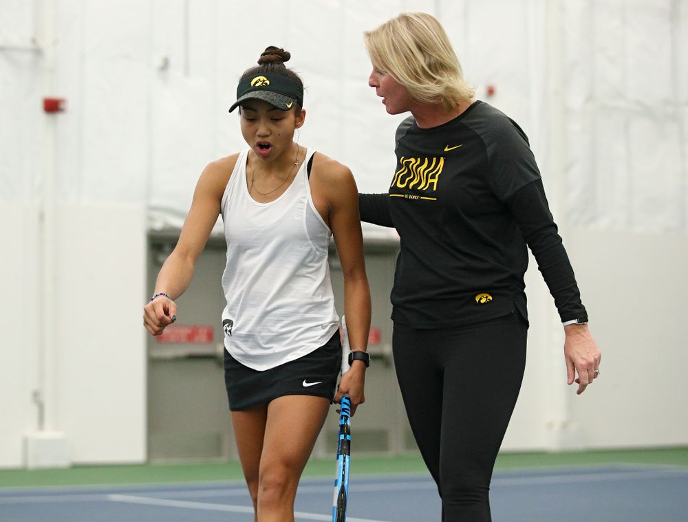 Iowa’s Michelle Bacalla (from left) talks with Sasha Schmid after winning a game during her singles match at the Hawkeye Tennis and Recreation Complex in Iowa City on Sunday, February 23, 2020. (Stephen Mally/hawkeyesports.com)