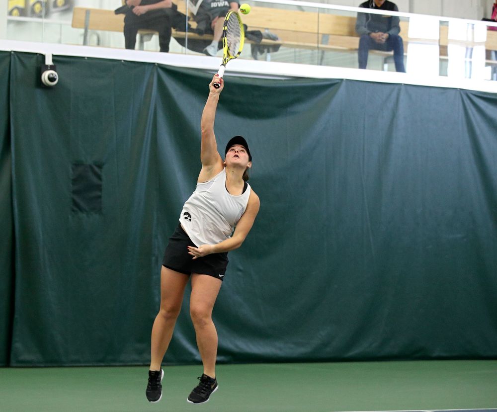 Iowa’s Danielle Bauers serves during her doubles match at the Hawkeye Tennis and Recreation Complex in Iowa City on Sunday, February 23, 2020. (Stephen Mally/hawkeyesports.com)