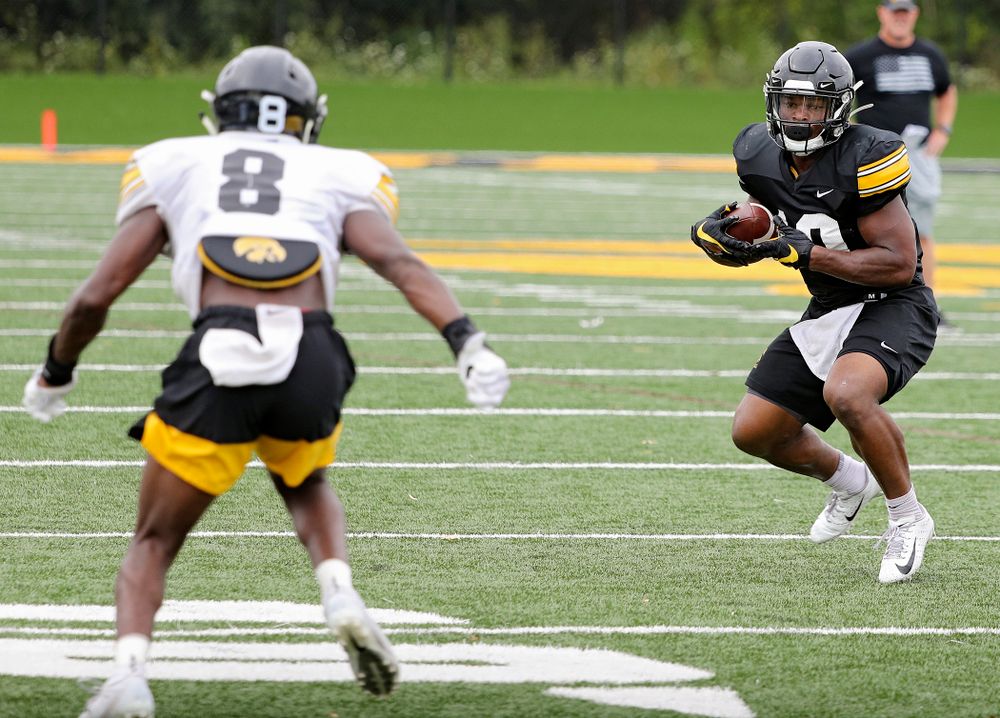 Iowa Hawkeyes running back Mekhi Sargent (10) eyes defensive back Matt Hankins (8) after pulling a pass during Fall Camp Practice No. 15 at the Hansen Football Performance Center in Iowa City on Monday, Aug 19, 2019. (Stephen Mally/hawkeyesports.com)
