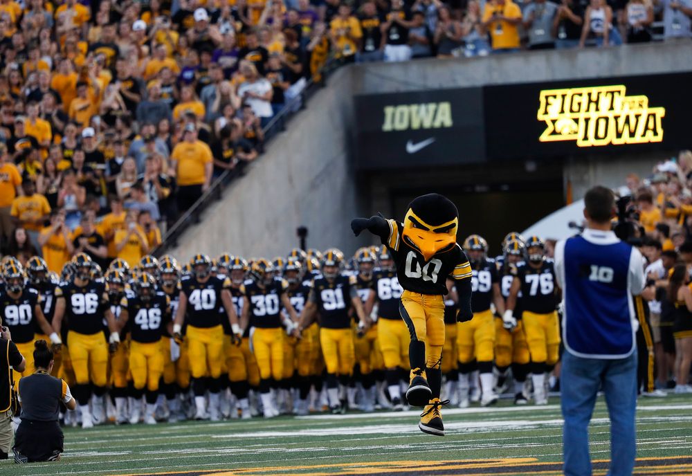 The Iowa Hawkeyes football team swarms the field before a game against Northern Iowa at Kinnick Stadium on September 15, 2018. (Tork Mason/hawkeyesports.com)