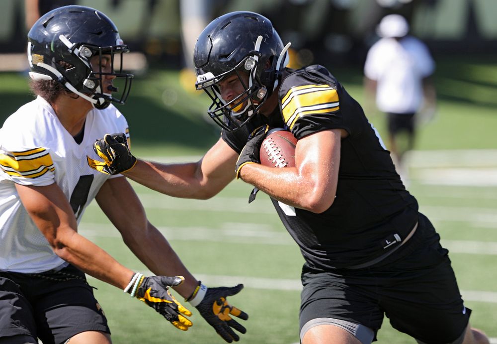 Iowa Hawkeyes wide receiver Nico Ragaini (89) tries to get around defensive back Dane Belton (4) after pulling in a pass during Fall Camp Practice No. 13 at the Hansen Football Performance Center in Iowa City on Friday, Aug 16, 2019. (Stephen Mally/hawkeyesports.com)