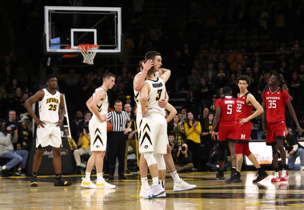 Iowa Hawkeyes forward Nicholas Baer (51) hugs guard Jordan Bohannon (3) as he leaves the court for the final time against the Rutgers Scarlet Knights  Saturday, March 2, 2019 at Carver-Hawkeye Arena. (Brian Ray/hawkeyesports.com)