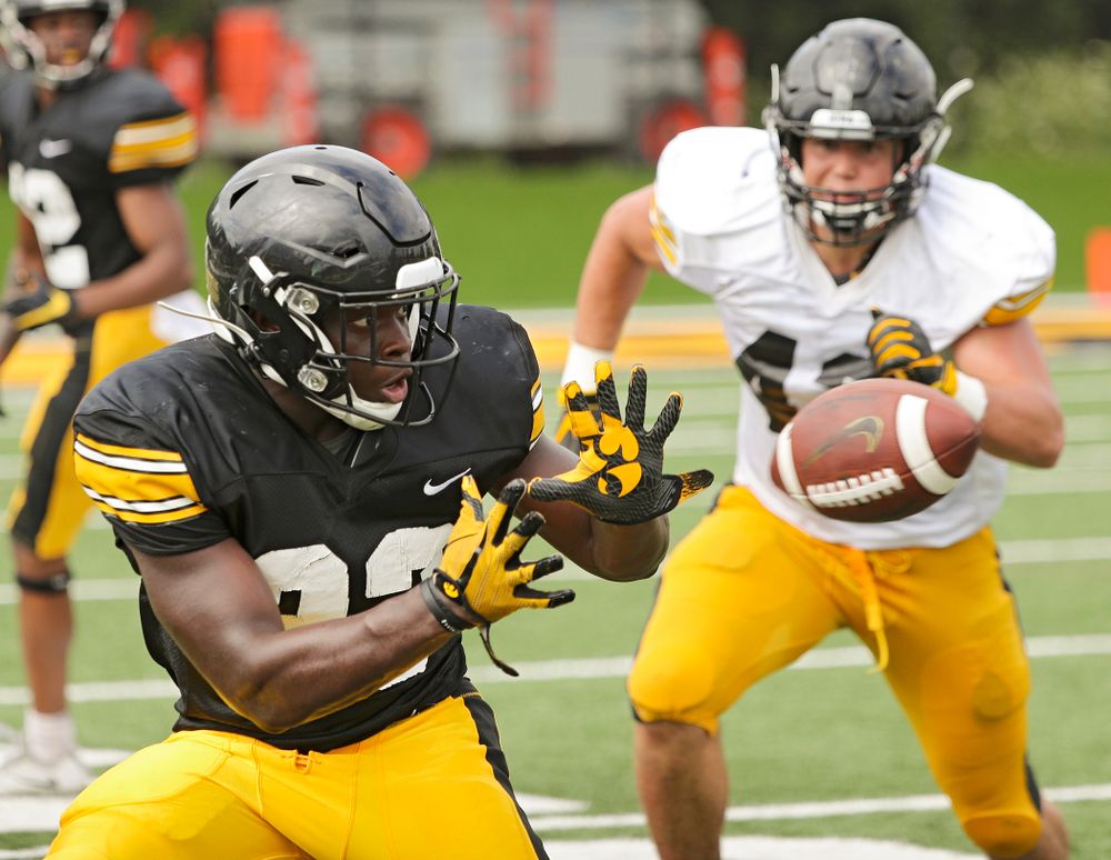 Iowa Hawkeyes running back Shadrick Byrd (23) pulls in a pass as linebacker Dillon Doyle (43) closes in during Fall Camp Practice No. 10 at the Hansen Football Performance Center in Iowa City on Tuesday, Aug 13, 2019. (Stephen Mally/hawkeyesports.com)