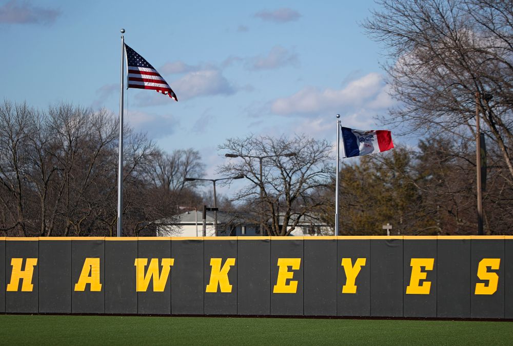 The flag of the United States and the state of Iowa fly during the first inning of the game at Duane Banks Field in Iowa City on Tuesday, March 3, 2020. (Stephen Mally/hawkeyesports.com)