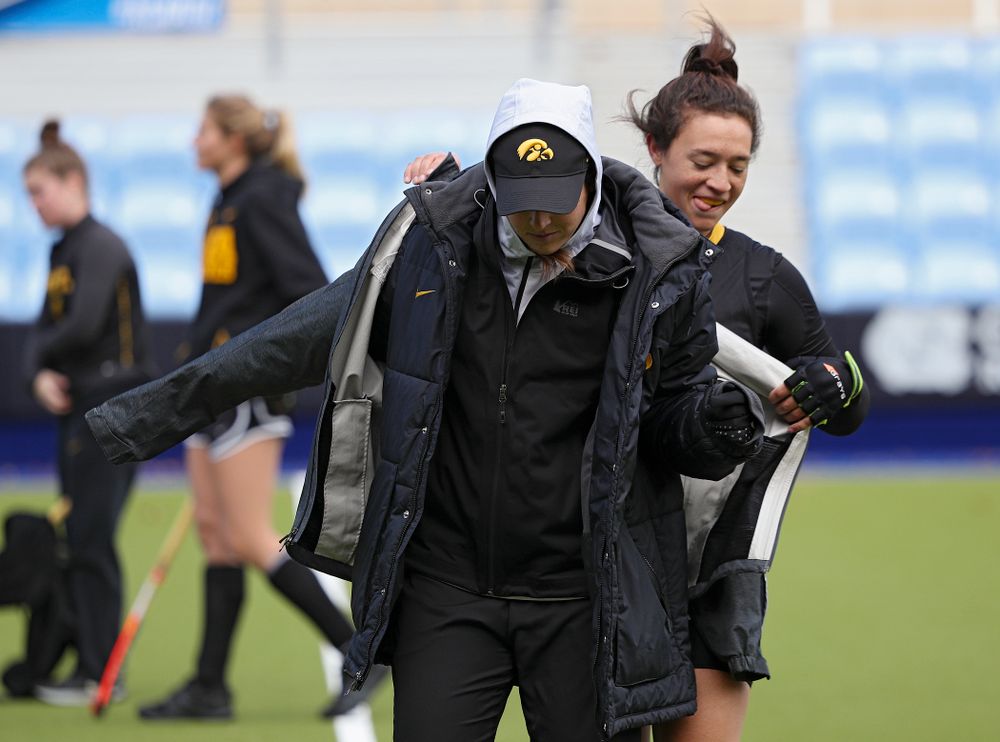 Iowa’s Mya Christopher (18) puts another coat on Ashley Renteria, strength coach, during their practice at Karen Shelton Stadium in Chapel Hill, N.C. on Saturday, Nov 16, 2019. (Stephen Mally/hawkeyesports.com)