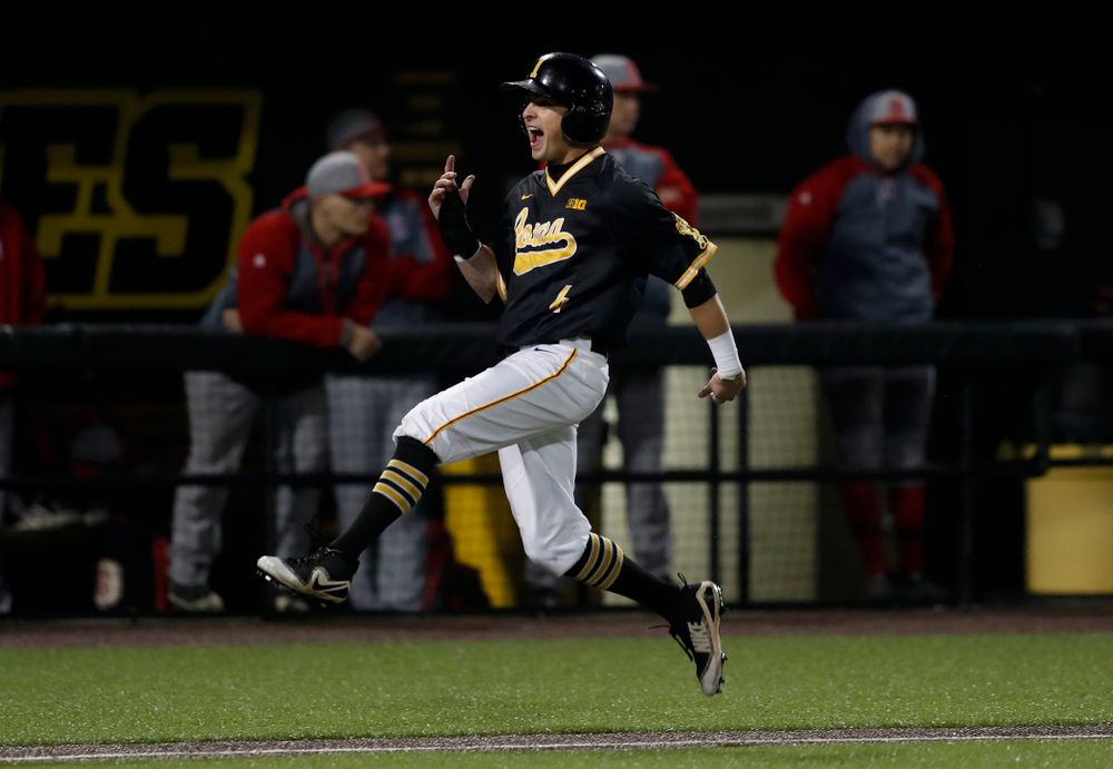 Iowa Hawkeyes infielder Mitchell Boe (4) celebrates as he scores on a walk off grand slam by catcher Tyler Cropley (5) against the Bradley Braves Wednesday, March 28, 2018 at Duane Banks Field. (Brian Ray/hawkeyesports.com)