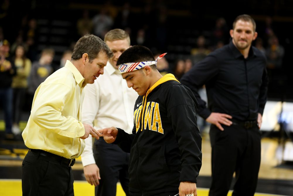 Iowa Hawkeyes head coach Tom Brands shakes hands with senior Pat Lugo during senior day activities Sunday, February 23, 2020 at Carver-Hawkeye Arena. (Brian Ray/hawkeyesports.com)