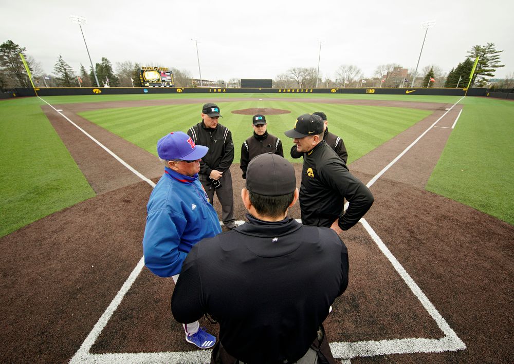 Iowa head coach Rick Heller meets at home plate before the college baseball game at Duane Banks Field in Iowa City on Wednesday, March 11, 2020. (Stephen Mally/hawkeyesports.com)