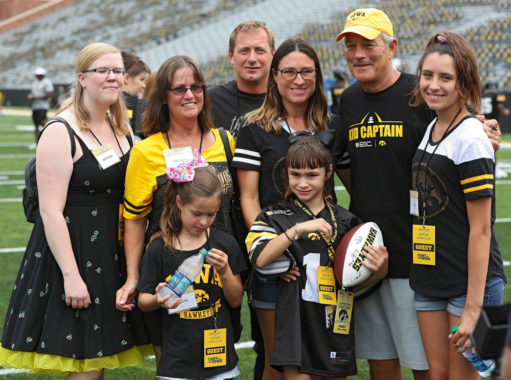 Kid Captain Aubrey Bussan-Kluesner and her family takes a picture with Iowa Hawkeyes head coach Kirk Ferentz during Kids Day at Kinnick Stadium in Iowa City on Saturday, Aug 10, 2019. (Stephen Mally/hawkeyesports.com)
