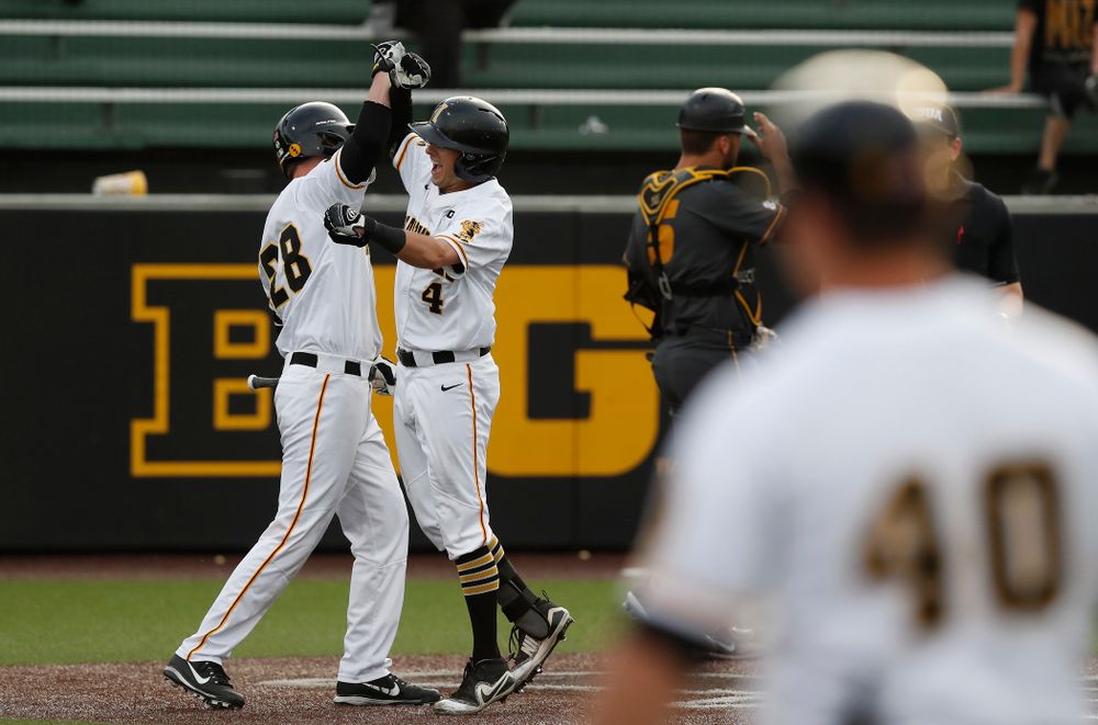Iowa Hawkeyes infielder Mitchell Boe (4) celebrates with infielder Chris Whelan (28) after hitting a home run against the Missouri Tigers Tuesday, May 1, 2018 at Duane Banks Field. (Brian Ray/hawkeyesports.com)