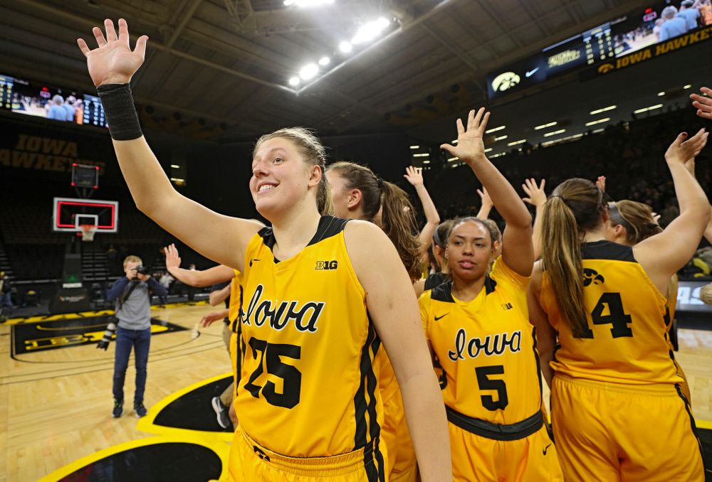 Iowa forward/center Monika Czinano (25) and guard Alexis Sevillian (5) wave to the crowd with their teammates after winning their game against Winona State at Carver-Hawkeye Arena in Iowa City on Sunday, Nov 3, 2019. (Stephen Mally/hawkeyesports.com)