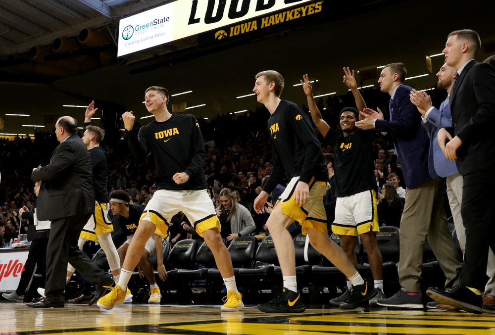 Iowa Hawkeyes guard Austin Ash (13) pumps his fist on the bench against the Michigan Wolverines Friday, January 17, 2020 at Carver-Hawkeye Arena. (Brian Ray/hawkeyesports.com)