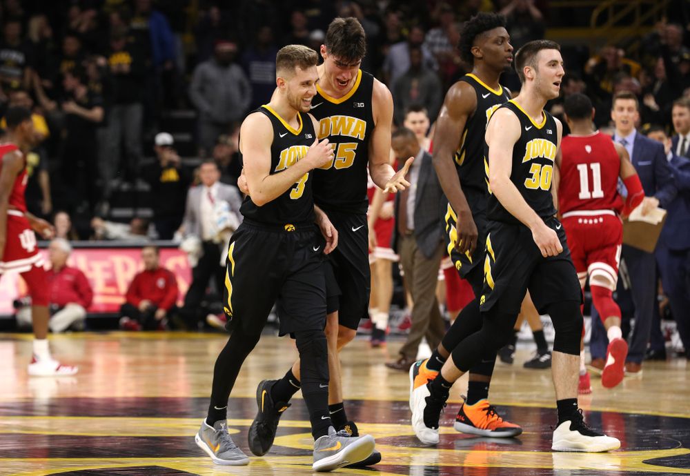 Iowa Hawkeyes guard Jordan Bohannon (3) celebrates with forward Luka Garza (55) after making a three point basket in overtime against the Indiana Hoosiers Friday, February 22, 2019 at Carver-Hawkeye Arena. (Brian Ray/hawkeyesports.com)