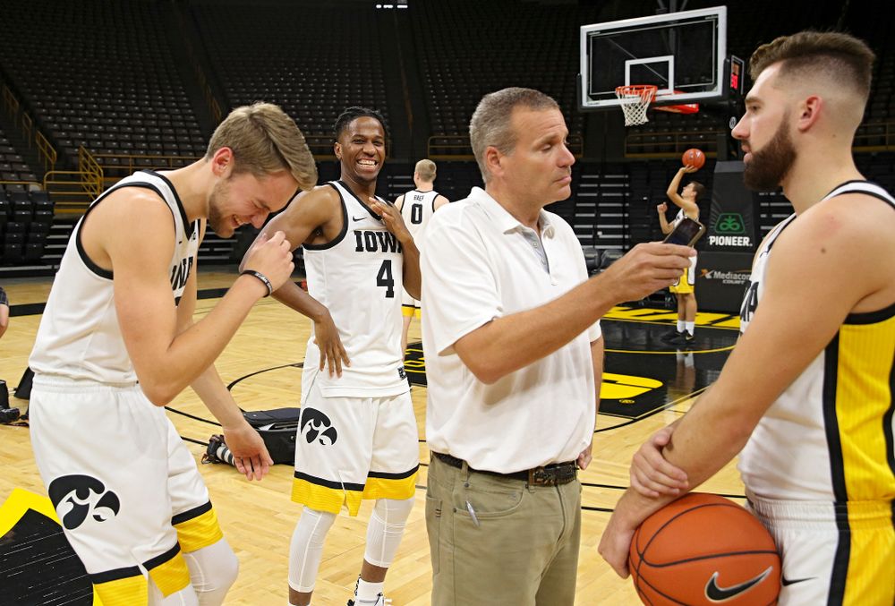 Iowa Hawkeyes forward Riley Till (20) and forward Bakari Evelyn (4) try to distract guard Jordan Bohannon (3) as he answers questions during Iowa Men’s Basketball Media Day at Carver-Hawkeye Arena in Iowa City on Wednesday, Oct 9, 2019. (Stephen Mally/hawkeyesports.com)